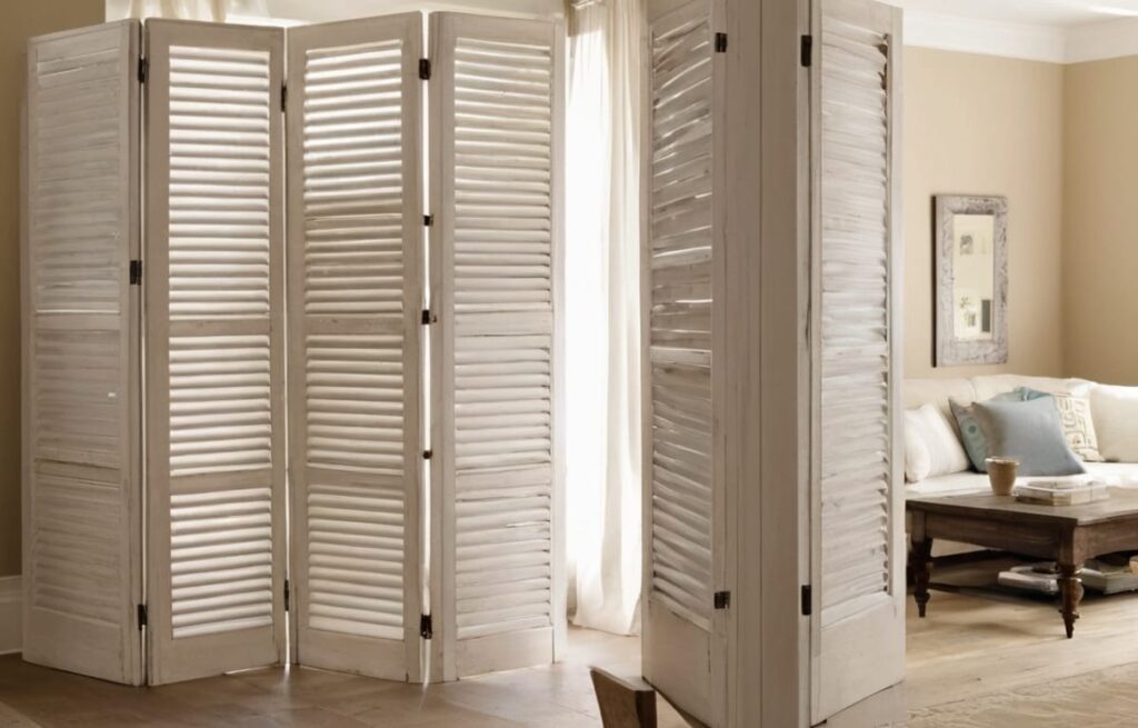 Transform old window shutters into a unique room divider
