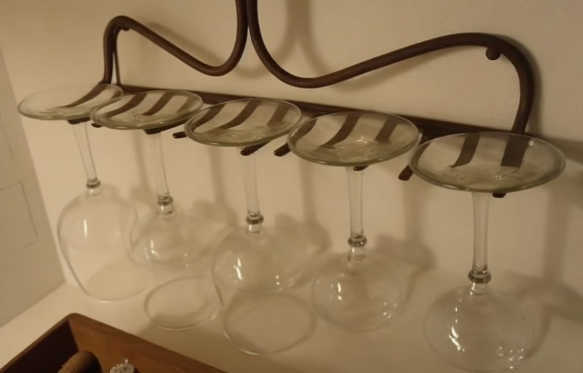 Transform a garden rake into a wine glass holder: